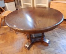 An oak circular top dining table, with moulded edge,