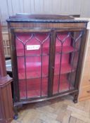 A Chippendale style bow front glazed bookcase, with gadrooned border,