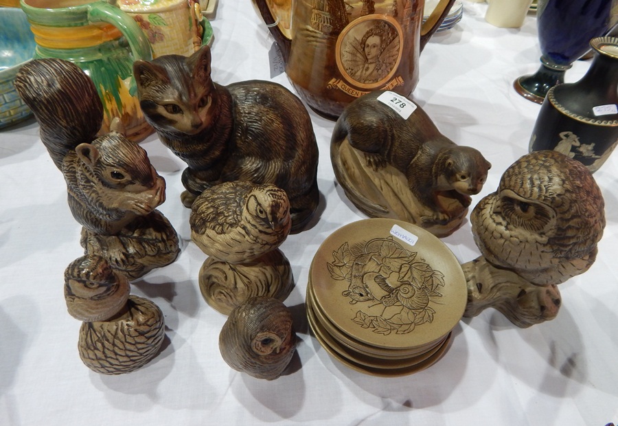 A collection of Poole animals and plates with incised animal scenes