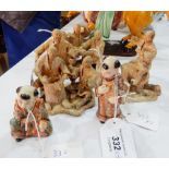 Two Japanese Satsuma pottery figures of young boys in decorative robes,