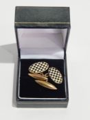 A pair of gentleman's 9ct gold oval cufflinks with enamel chequerwork design