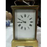 Early 20th century brass carriage clock, plain enamel dial, Roman numerals,