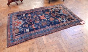 Persian style wool rug the blue ground central field with geometric motifs and having three guard