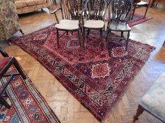 A Shiraz red ground rug,