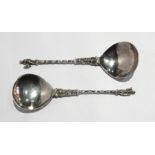 A pair of continental apostle spoons with spiral handles and figure finials,