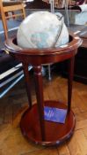 The Cram classic globe with gimbal mount on a mahogany stand, with turned tapering supports,