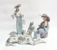 A Lladro seated lady, 21cm, a Lladro ceramic lady walking a dog, 20cm and a Lladro great dane,