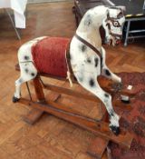 An old dapple grey rocking horse with glass eyes, on twin pedestal rocking frame,