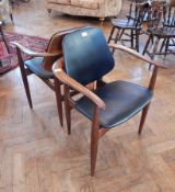 A pair of modern armchairs, with upholstered back and seat,