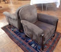 A pair of suede leather armchairs,