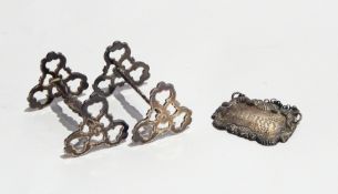 A pair of George IV silver knife rests, London 1824 and a silver sherry decanter label,