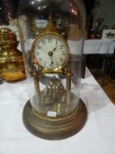 A 400 day two pillar brass clock with glass dome