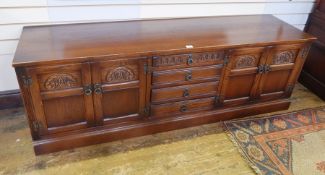 Old Charm "Tudor" reproduction oak sideboard with nest of drawers flanked by pair cupboards,