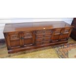 Old Charm "Tudor" reproduction oak sideboard with nest of drawers flanked by pair cupboards,