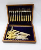 Set of 12 dessert forks and knives with bone handles and floral engraving,