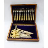 Set of 12 dessert forks and knives with bone handles and floral engraving,