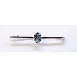 18ct white gold and aquamarine bar brooch having central oval cut aquamarine in raised setting