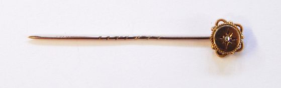 9ct gold and diamond stick pin, the central rose-cut diamond inset star, in circular terminal,