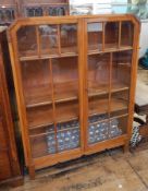 1930's stained oak astragal-glazed bookcase with three shelves, on block tapering supports,