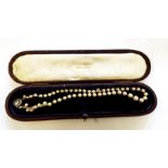 String of graduated real pearls with rose cut diamond clasp set with central stone, 1ct approx.