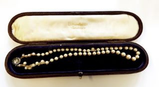 String of graduated real pearls with rose cut diamond clasp set with central stone, 1ct approx.