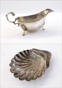 George V silver gravy boat with gadrooned borders, scroll handle, on shell pad feet, Sheffield 1935,