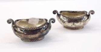 Pair of Victorian silver oval open salts with gadrooned borders, scroll handles, glass liners,