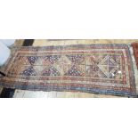 Eastern wool runner with five geometric lozenges, midnight blue field, multiple floral borders,