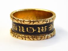 Victorian 18ct gold memorial ring with embossed floral border having central black enamel ring