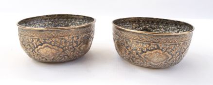 Pair of Eastern silver plate on copper bowls with foliate repousse decoration,