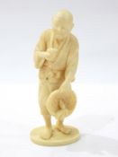 Japanese carved ivory figure of a man holding bird and basket with radish, on oval base, signed, 12.