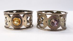 Pair of George V silver napkin rings of open fretwork design, inset with amethyst and citrine,