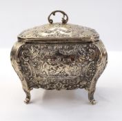 Continental silver tea caddy with hinged cover, repousse rococo decoration, raised on cabriole legs,