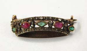 Gold-coloured metal, ruby, emerald and diamond coronet brooch set with two rubies,