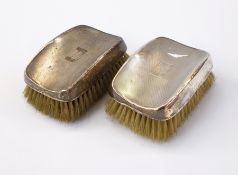 Pair of George VI gentleman's silver-backed hairbrushes of engine-turned design,