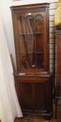 Reproduction mahogany corner cupboard, the astragal glazed door enclosing shelves,