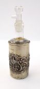 Edwardian silver-cased scent bottle with glass stopper, foliate repousse decoration,