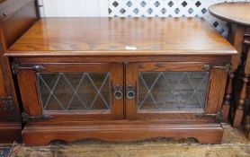 Old Charm "Tudor" low side cabinet enclosed by pair lead light panel doors,