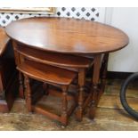 Nest of three Old Charm "Tudor" occasional tables having oval tops and each on baluster turned