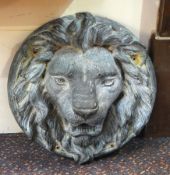 Lead lion's mask pattern garden water spout, in circular surround,