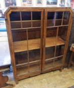 1930's oak astragal-glazed bookcase with three shelves, on block tapering supports,