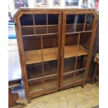 1930's oak astragal-glazed bookcase with three shelves, on block tapering supports,