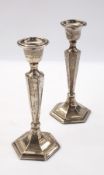 Pair of George V silver table candlesticks of hexagonal form, the tapering columns on a raised foot,