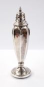 George V silver pepperpot of tapering reeded form, raised on a circular foot, Birmingham 1927,