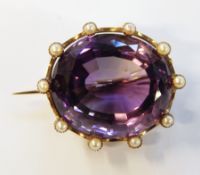 Gold-coloured metal, pearl and amethyst brooch with central oval faceted amethyst,