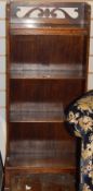 Oak narrow four-tier bookcase with pierced scroll raised back, on square section supports,