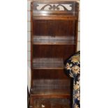 Oak narrow four-tier bookcase with pierced scroll raised back, on square section supports,