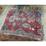Eastern wool rug with asymmetric design, on red field,
