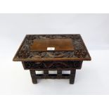 Chinese carved hardwood folding stool table with ornate dragon carving to the top and Oriental