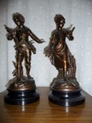 A pair of French Spelter figures of a young boy holding a birds nest 'L'ecole Buissonniere' and a